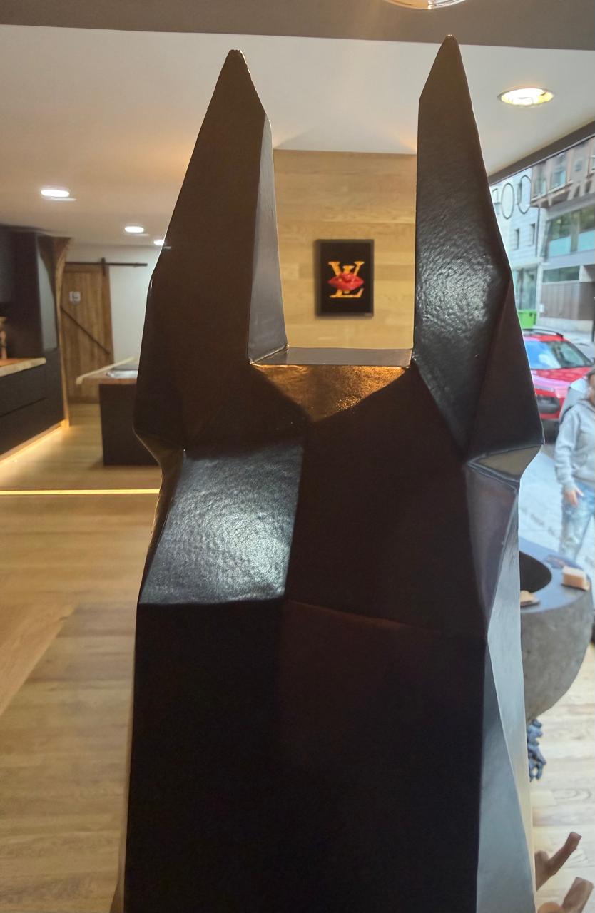 Detalle del dóberman con obra enmarcada de Brother X al fondo